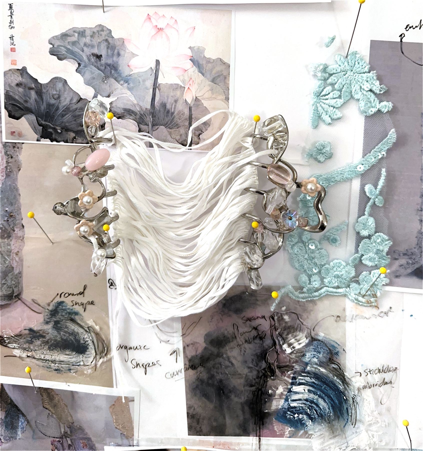 Draped white fabric pinned over a collage wall